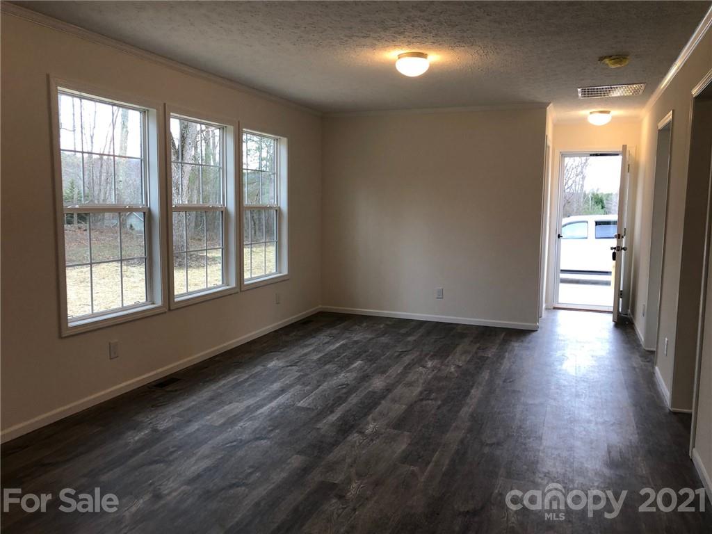318 Souther Road Fletcher, NC 28732 - Photo 12 of 19 a view of an empty room with wooden floor and a window