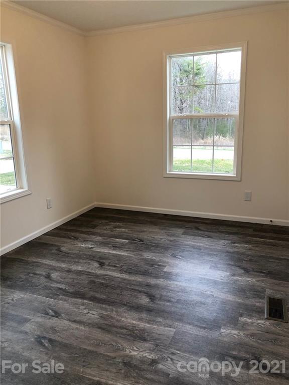318 Souther Road Fletcher, NC 28732 - Photo 16 of 19 an empty room with wooden floor and windows