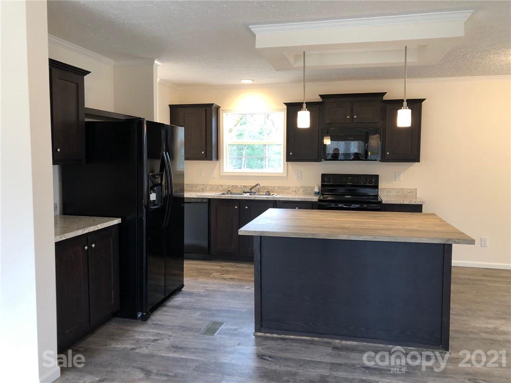 318 Souther Road Fletcher, NC 28732 - Photo 8 of 19 a kitchen with a sink a refrigerator and a stove top oven