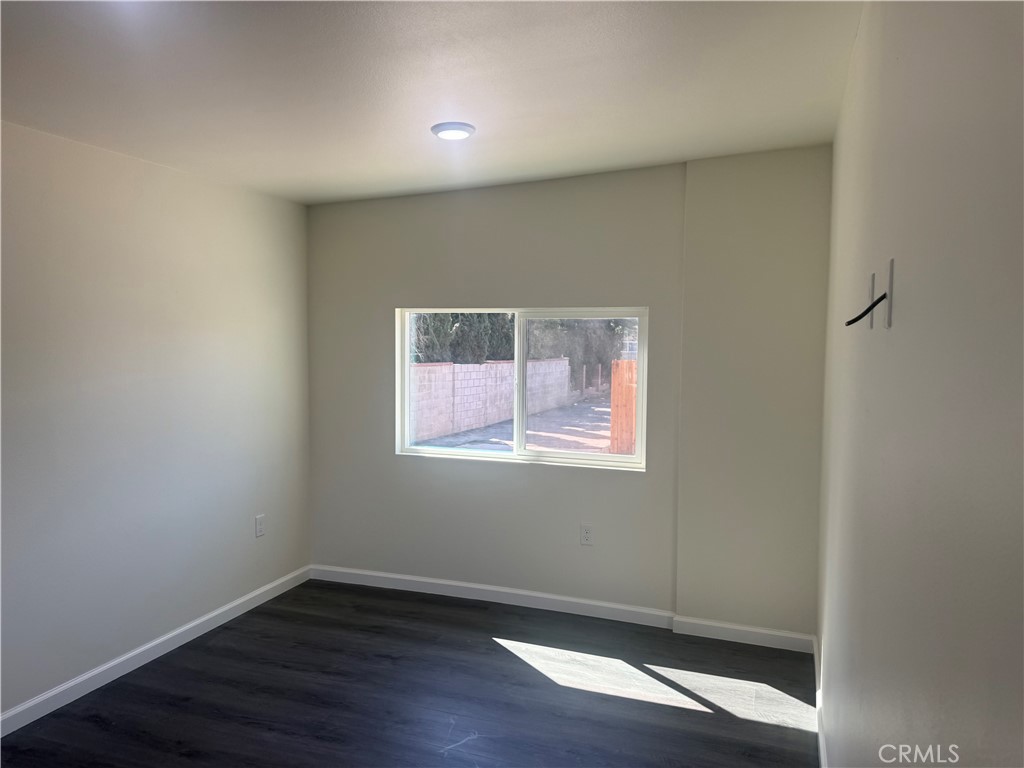 10337 Mull Avenue Riverside, CA 92505 - Photo 24 of 28 an empty room with wooden floor and windows