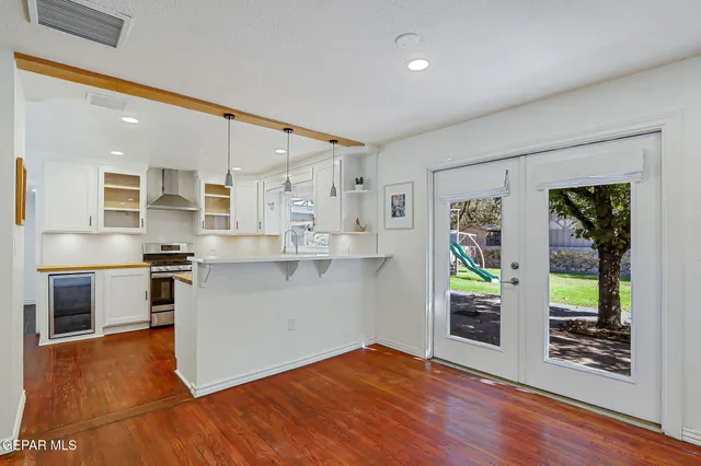 a kitchen with wooden floor and a stove top oven