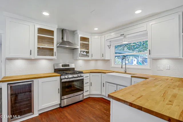 a kitchen with stainless steel appliances granite countertop a sink and cabinets