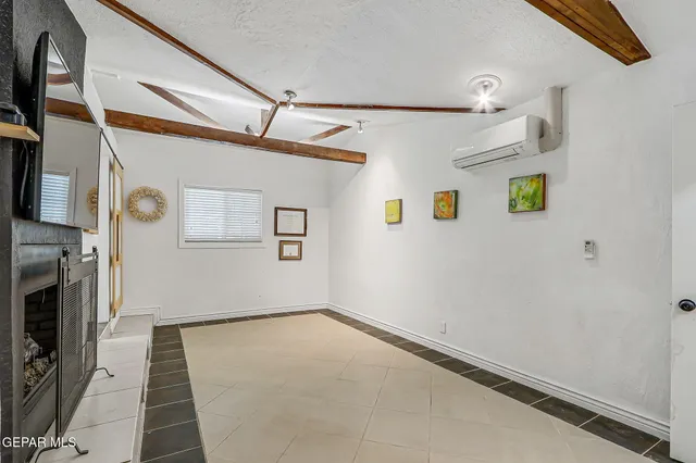 a view of a room with wooden floor and window