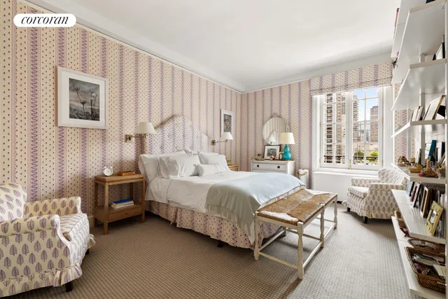 a living room with a bed furniture and a window