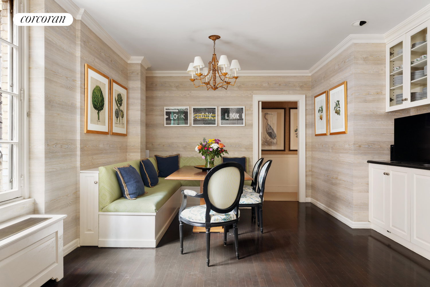 137 East 66th Street, Unit 8AB Manhattan, NY 10065 - Photo 8 of 18 a living room with furniture a chandelier and a flat screen tv