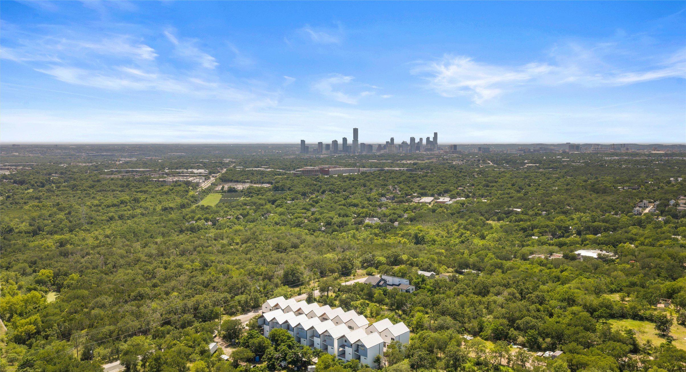 5912 Harold Court, Unit 107 Austin, TX 78721 - Photo 3 of 35 An aerial view of the community's green, connected East Austin setting, with quick access to the city and major routes. Model No. 105 Shown.