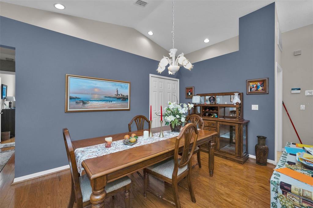 9630 Green Needle Drive New Port Richey, FL 34655 - Photo 11 of 83 a view of a dining room with furniture and wooden floor