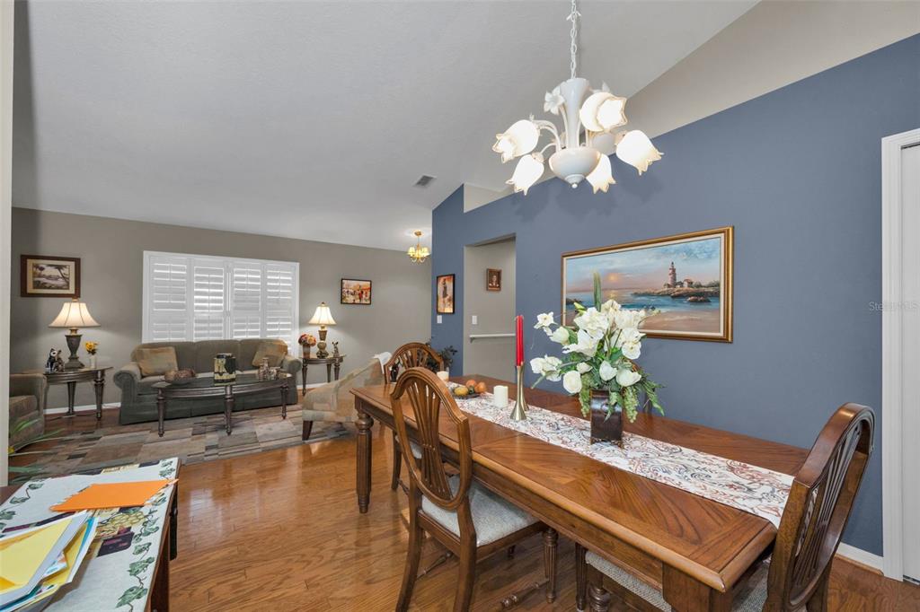 9630 Green Needle Drive New Port Richey, FL 34655 - Photo 12 of 83 a dining room filled chandelier and wooden floor