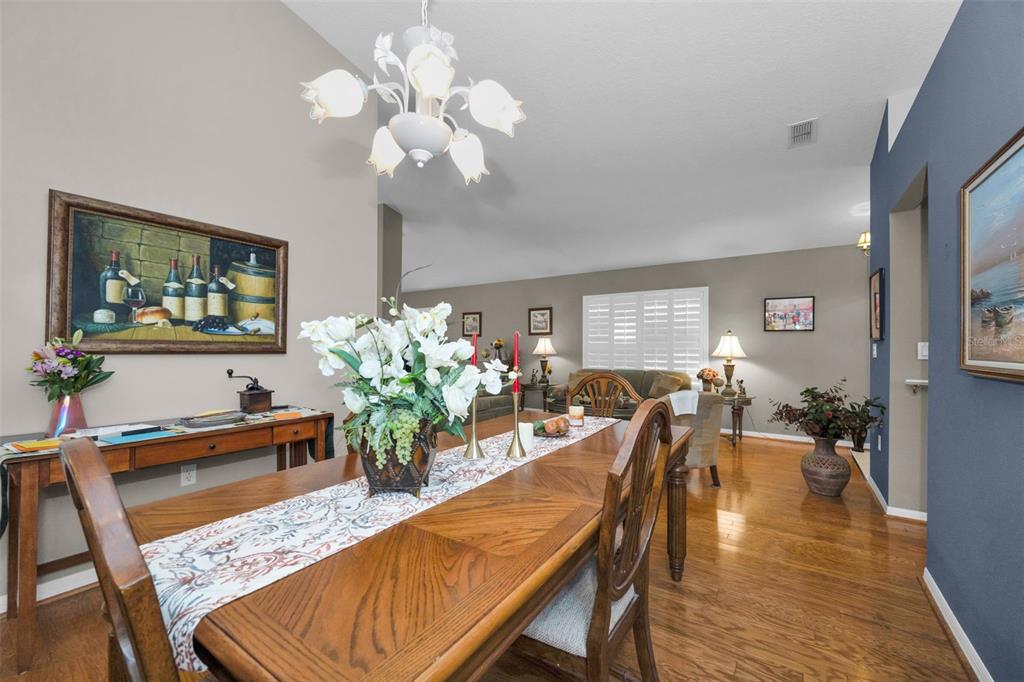 9630 Green Needle Drive New Port Richey, FL 34655 - Photo 13 of 83 a view of a dining room with furniture and wooden floor
