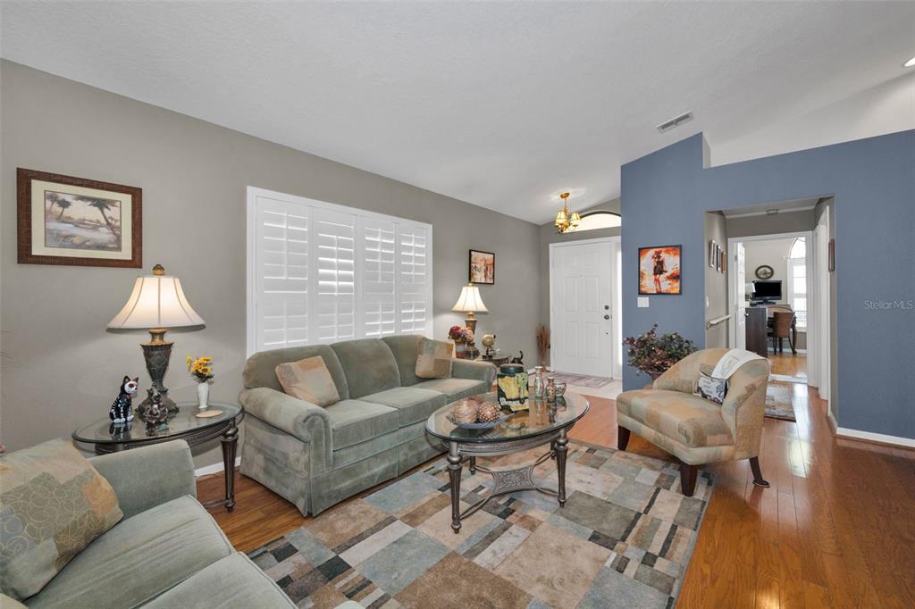 9630 Green Needle Drive New Port Richey, FL 34655 - Photo 15 of 83 a living room with furniture a lamp and a large window