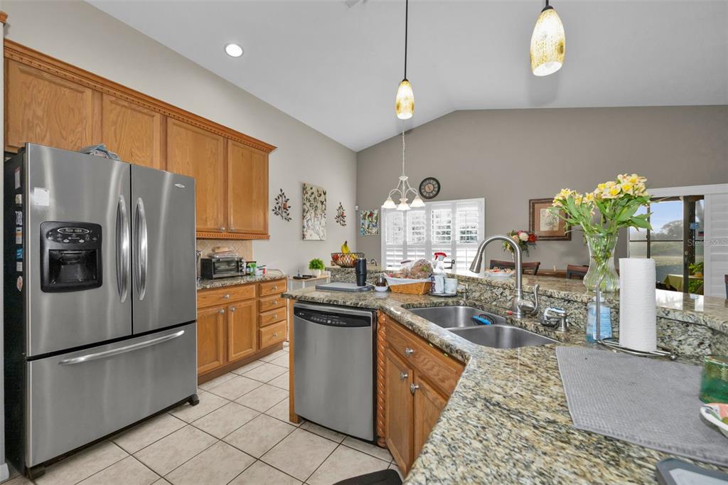 9630 Green Needle Drive New Port Richey, FL 34655 - Photo 18 of 83 a kitchen with granite countertop a sink stainless steel appliances and cabinets
