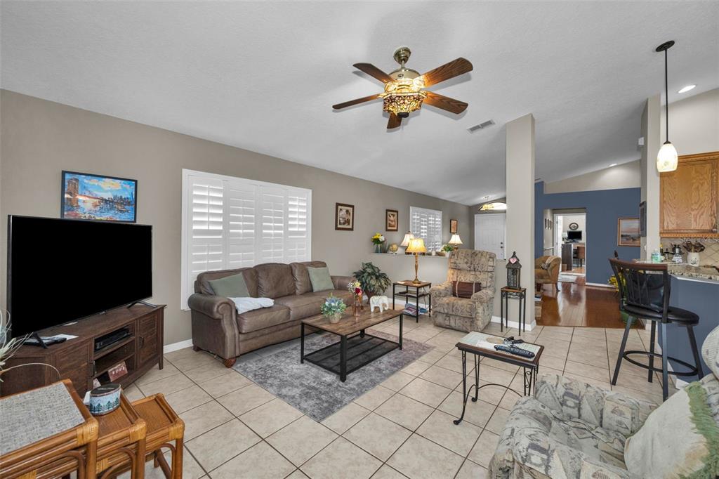 9630 Green Needle Drive New Port Richey, FL 34655 - Photo 24 of 83 a living room with furniture and a flat screen tv