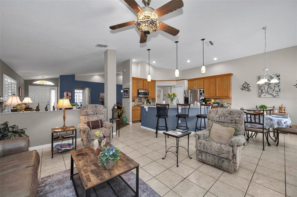 9630 Green Needle Drive New Port Richey, FL 34655 - Photo 25 of 83 a living room with furniture kitchen view and a chandelier