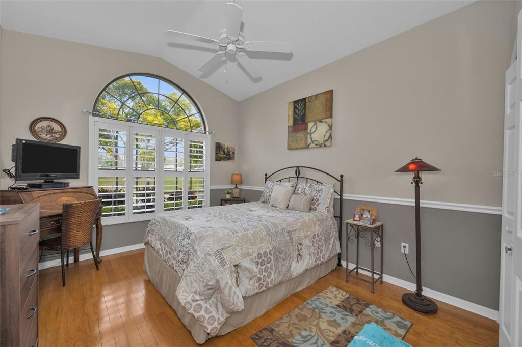 9630 Green Needle Drive New Port Richey, FL 34655 - Photo 32 of 83 a bedroom with a bed and a flat screen tv