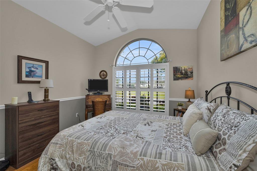 9630 Green Needle Drive New Port Richey, FL 34655 - Photo 33 of 83 a bedroom with a large bed and a flat tv screen on dresser