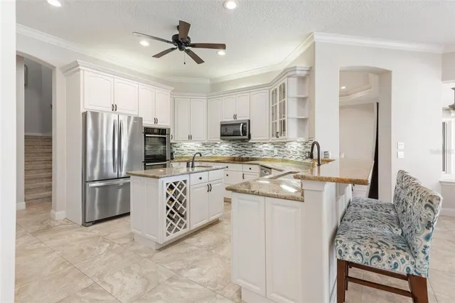 a kitchen with granite countertop a refrigerator and a sink