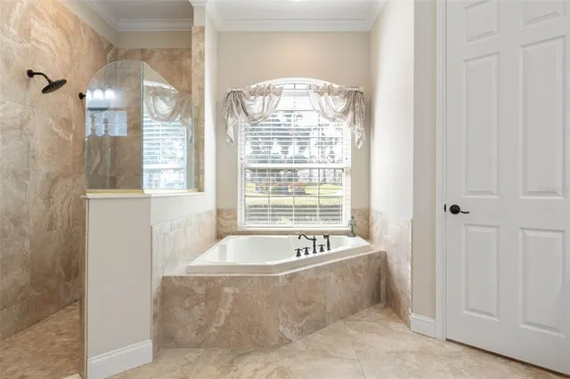 a bedroom with a bed and ceiling fan