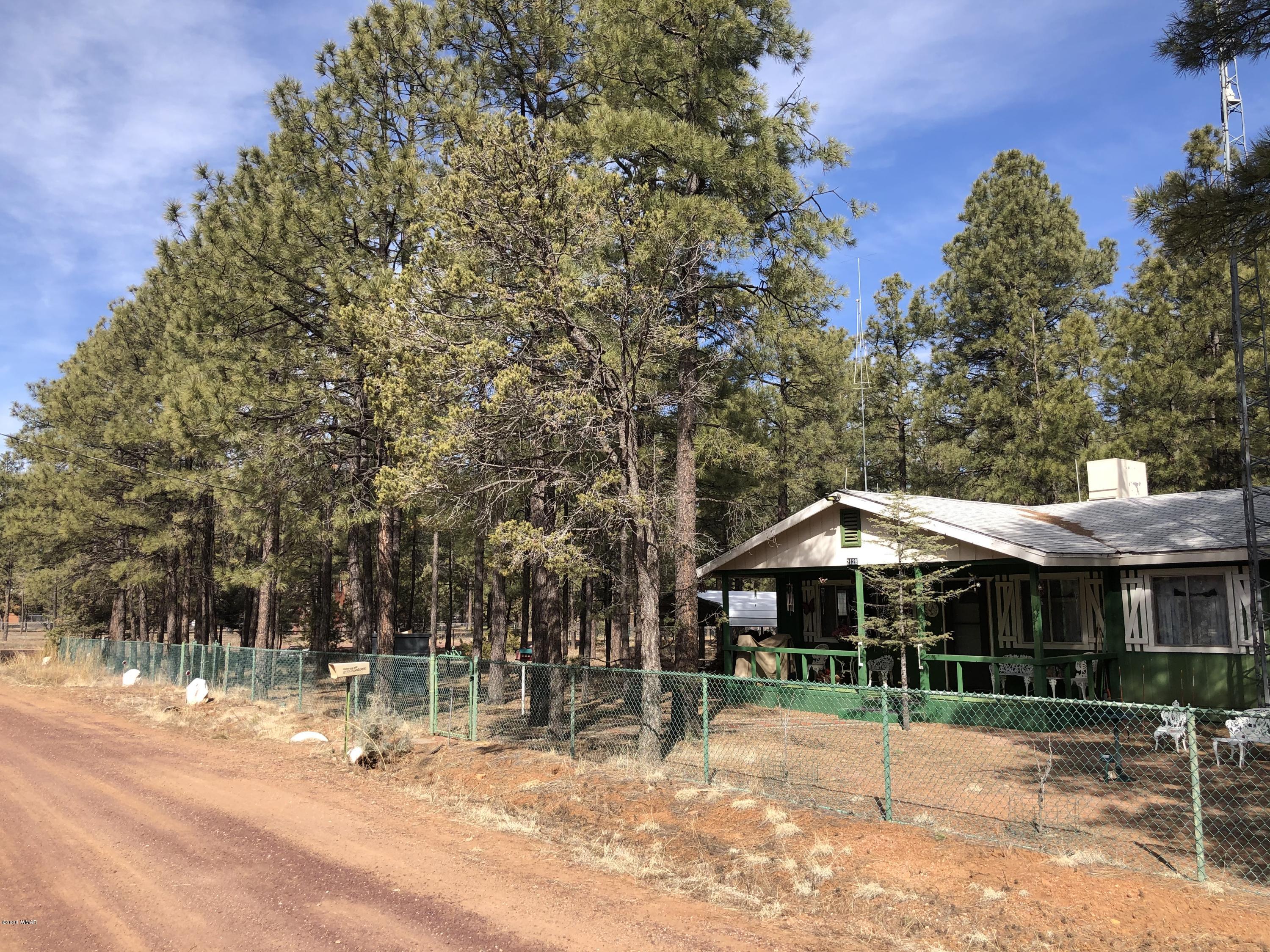 2128 Pony Road Overgaard, AZ 85933 - Photo 2 of 3 a backyard of a house with table and chairs