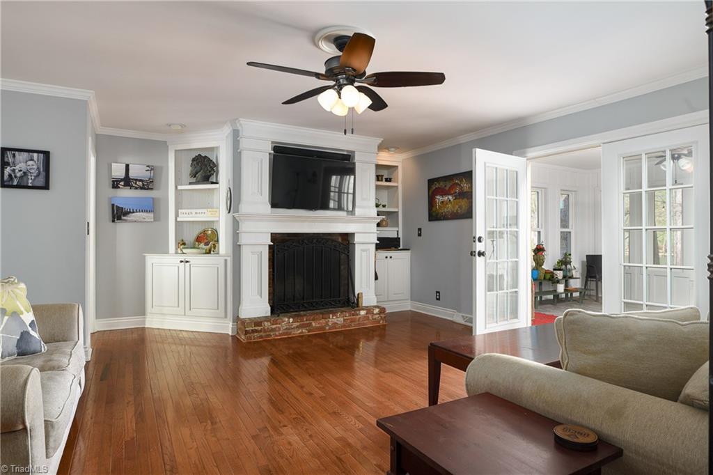2141 Walker Road Winston-Salem, NC 27106 - Photo 11 of 50 Beautiful hardwood floors in living room leading to the gorgeous sunroom