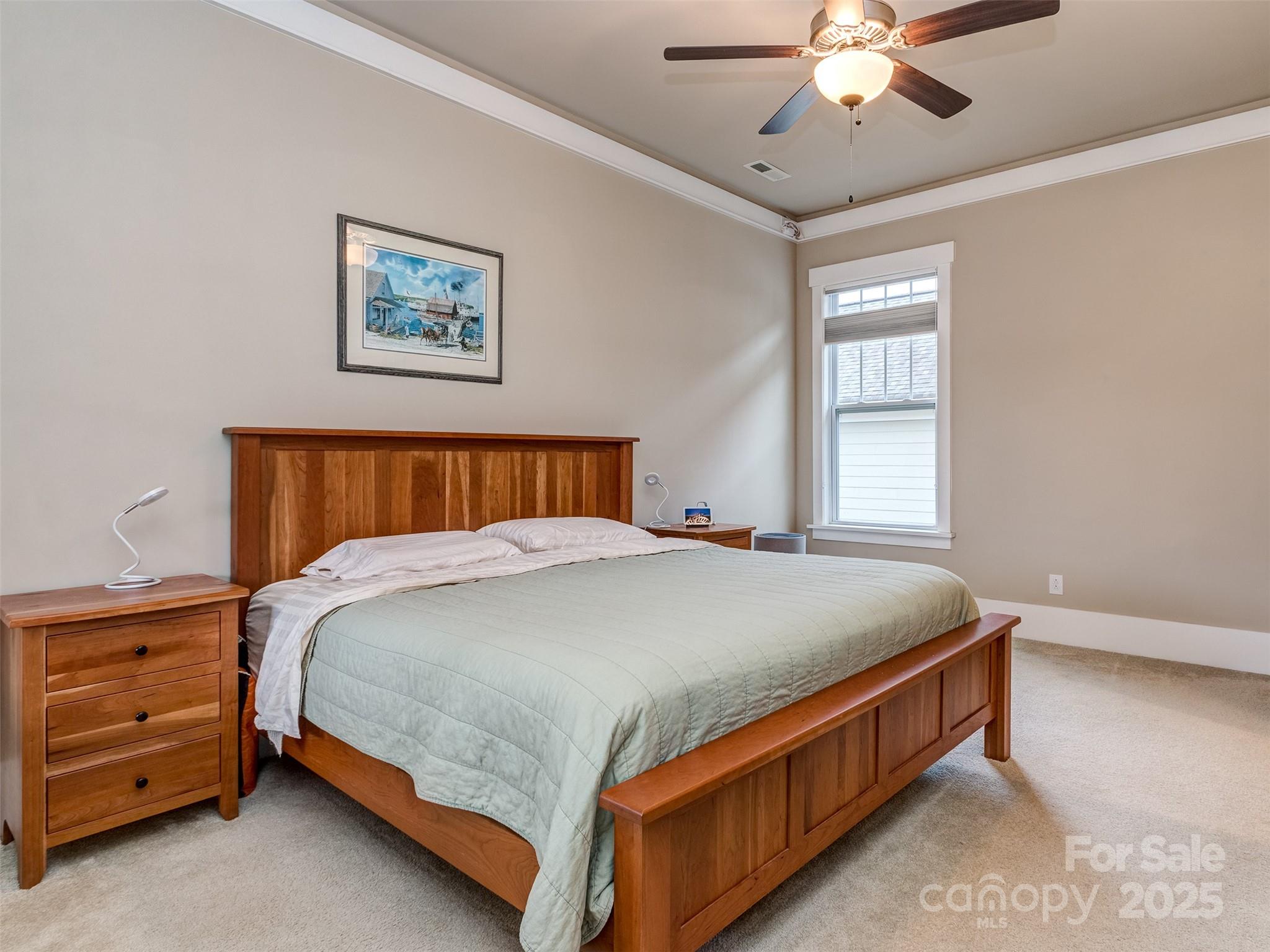 1055 Ridge Runner Road Rock Hill, SC 29730 - Photo 13 of 43 a bed sitting in a bedroom next to a window and a chandelier