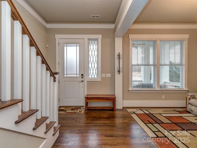 a view of an entryway with wooden floor and stairs