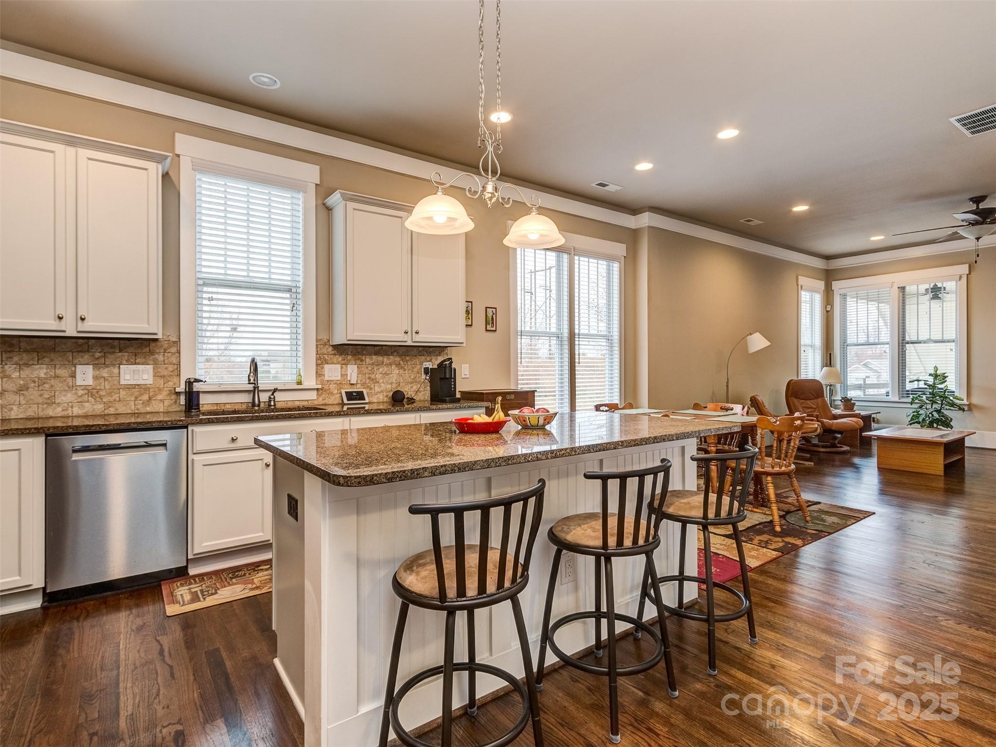 1055 Ridge Runner Road Rock Hill, SC 29730 - Photo 9 of 43 a kitchen with a dining table chairs sink and white appliances