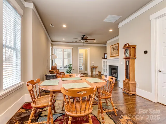 a dining room with furniture window and wooden floor