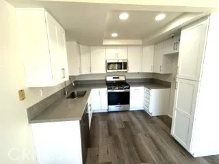 a kitchen with stainless steel appliances granite countertop a stove a sink and a refrigerator