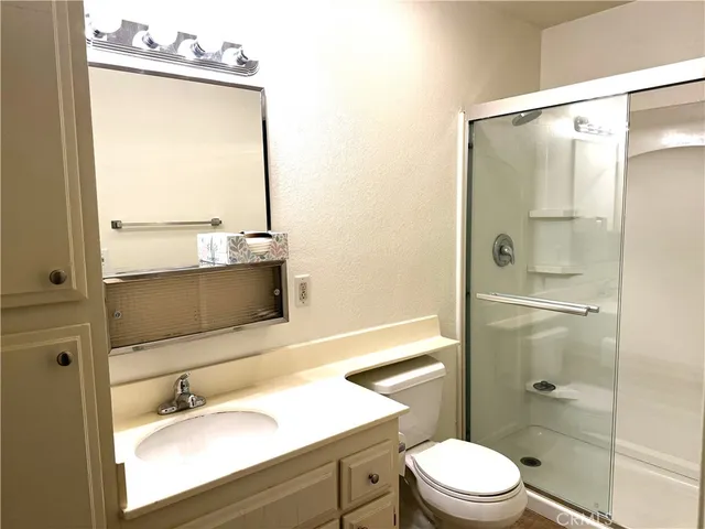 a bathroom with a sink vanity mirror and toilet