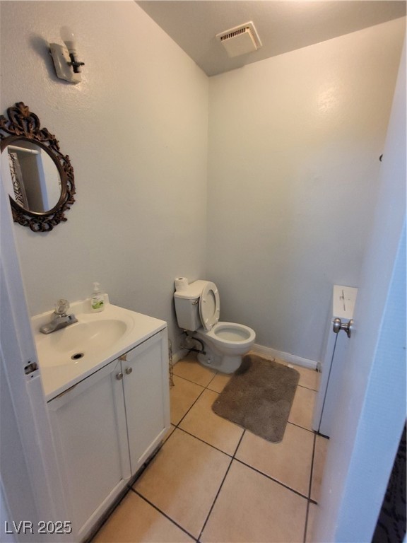 4150 Solteros Street, Unit 1 Las Vegas, NV 89103 - Photo 23 of 25 Half bathroom with light tile patterned flooring and vanity