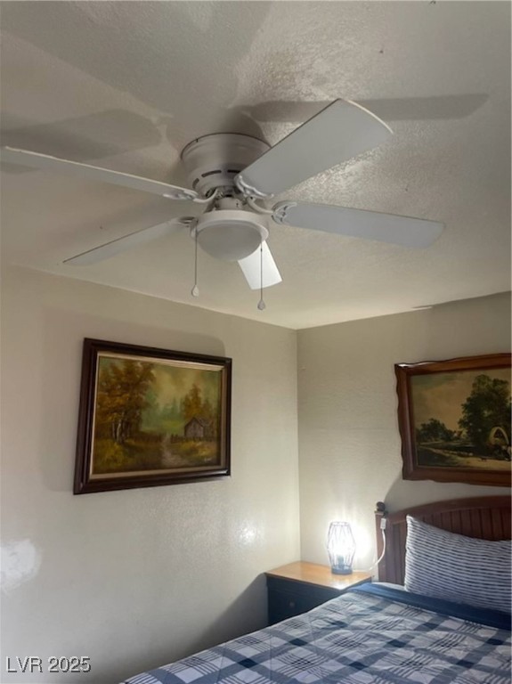 4150 Solteros Street, Unit 1 Las Vegas, NV 89103 - Photo 5 of 25 Bedroom with ceiling fan and a textured ceiling