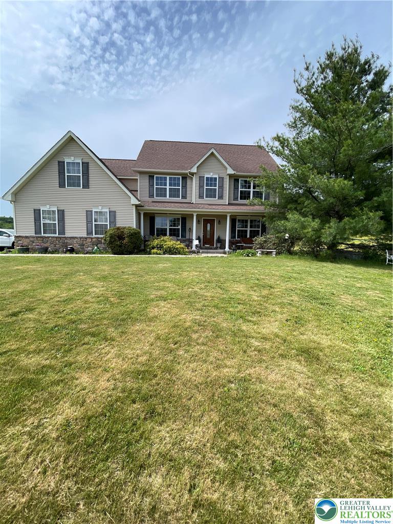 707 Gilbert Road Gilbert, PA 18331 - Photo 2 of 56 a front view of a house with a garden