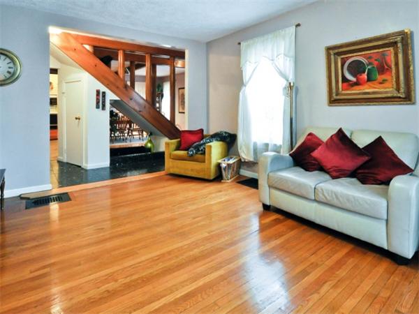 14 Beach Street, Unit 14 Newton, MA 02458 - Photo 2 of 15 a living room with furniture floor to ceiling window and wooden floor