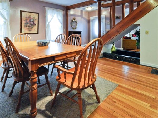 14 Beach Street, Unit 14 Newton, MA 02458 - Photo 4 of 15 a dining room with furniture a floor to ceiling window and wooden floor