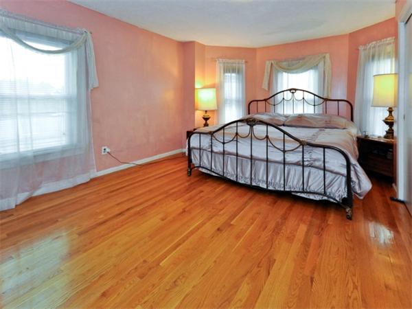 14 Beach Street, Unit 14 Newton, MA 02458 - Photo 9 of 15 a bedroom with a bed lamp and a window