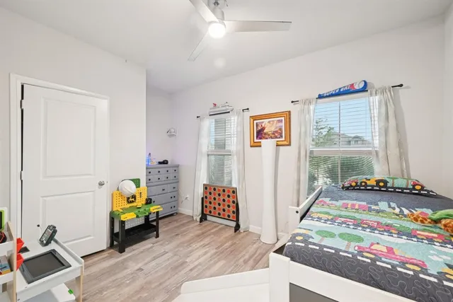 a bedroom with bed and wooden floor