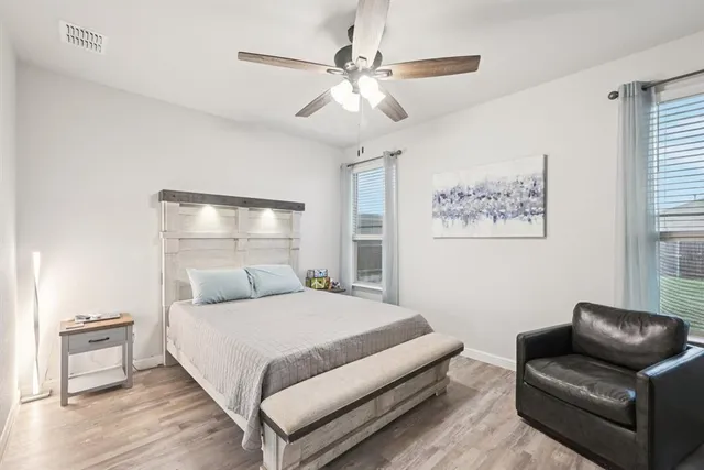 a bedroom with furniture and a flat screen tv