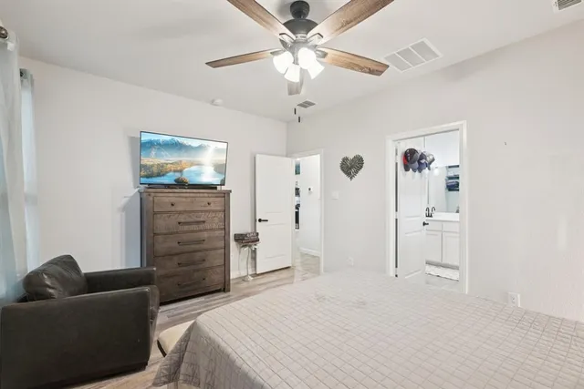 a bedroom with a bed and a dresser