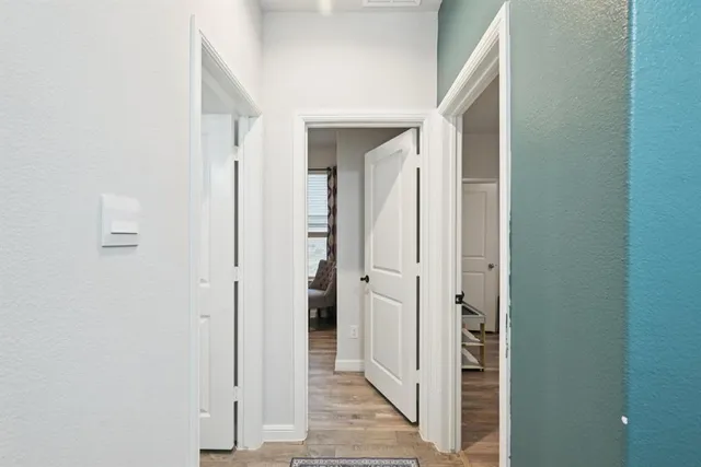 a view of a hallway with a wooden door