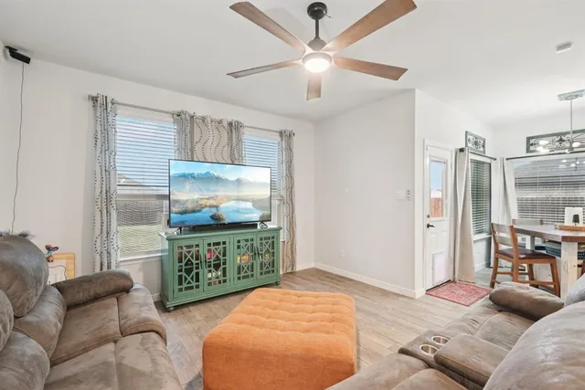 a bedroom with furniture and a flat screen tv