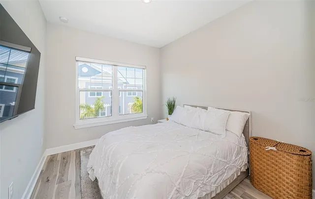 a large bed sitting in a bedroom next to a window