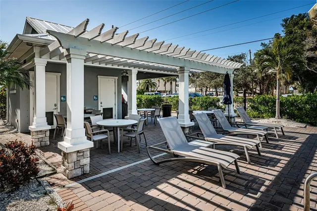 a view of a patio with table and chairs and potted plants