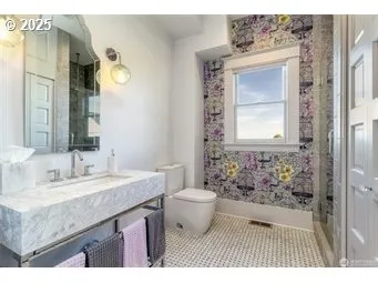 a bathroom with a granite countertop sink toilet and shower