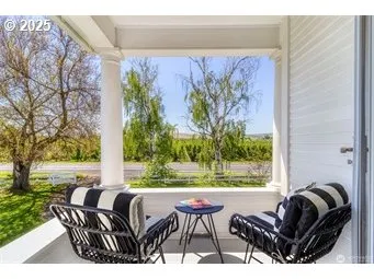 a view of a chairs and table in patio with a yard