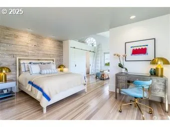 a bed room with a bed and a chair