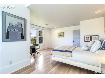 a bedroom with a bed and a painting on the wall