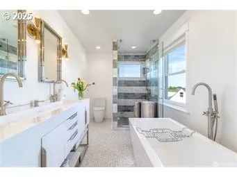 a bathroom with a double vanity sink a mirror and a bathtub