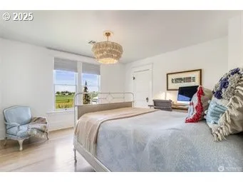 a bedroom with a bed and a chandelier