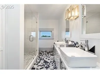 a bathroom with a sink a toilet a mirror and shower