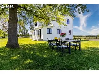 a view of a house with a backyard